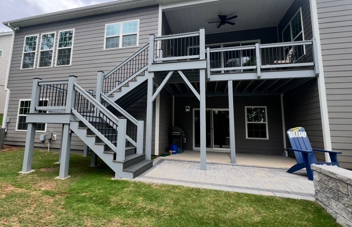 Two-Level Deck Masterpiece with Gray Wood and Black Railings image